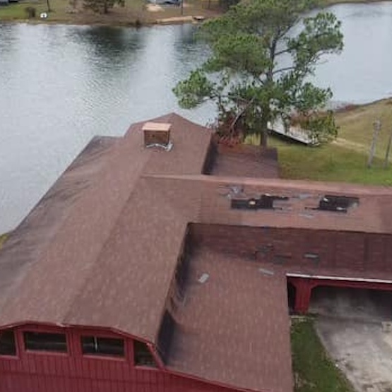 A reddish roof that has been newly repaired.